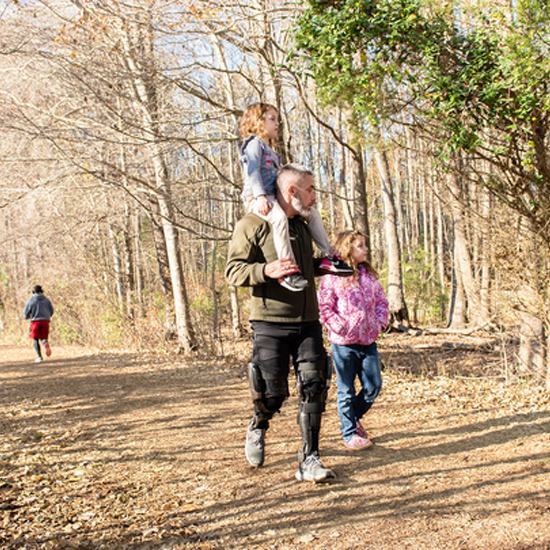 A man wearing a C-Brace, walking with his daughters in New York and New Jersey