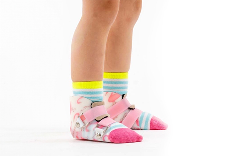A child's foot in a car-printed brace, showcasing the importance of quality orthotic care in New York