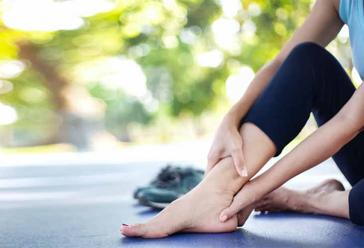 closeup of woman holding her ankle