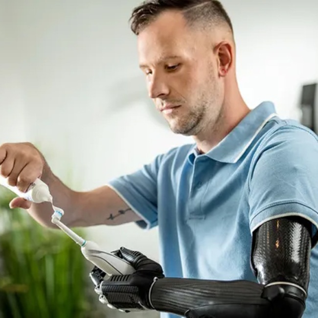 Man with a prosthetic arm brushes his teeth in New York, New Jersey, & Connecticut